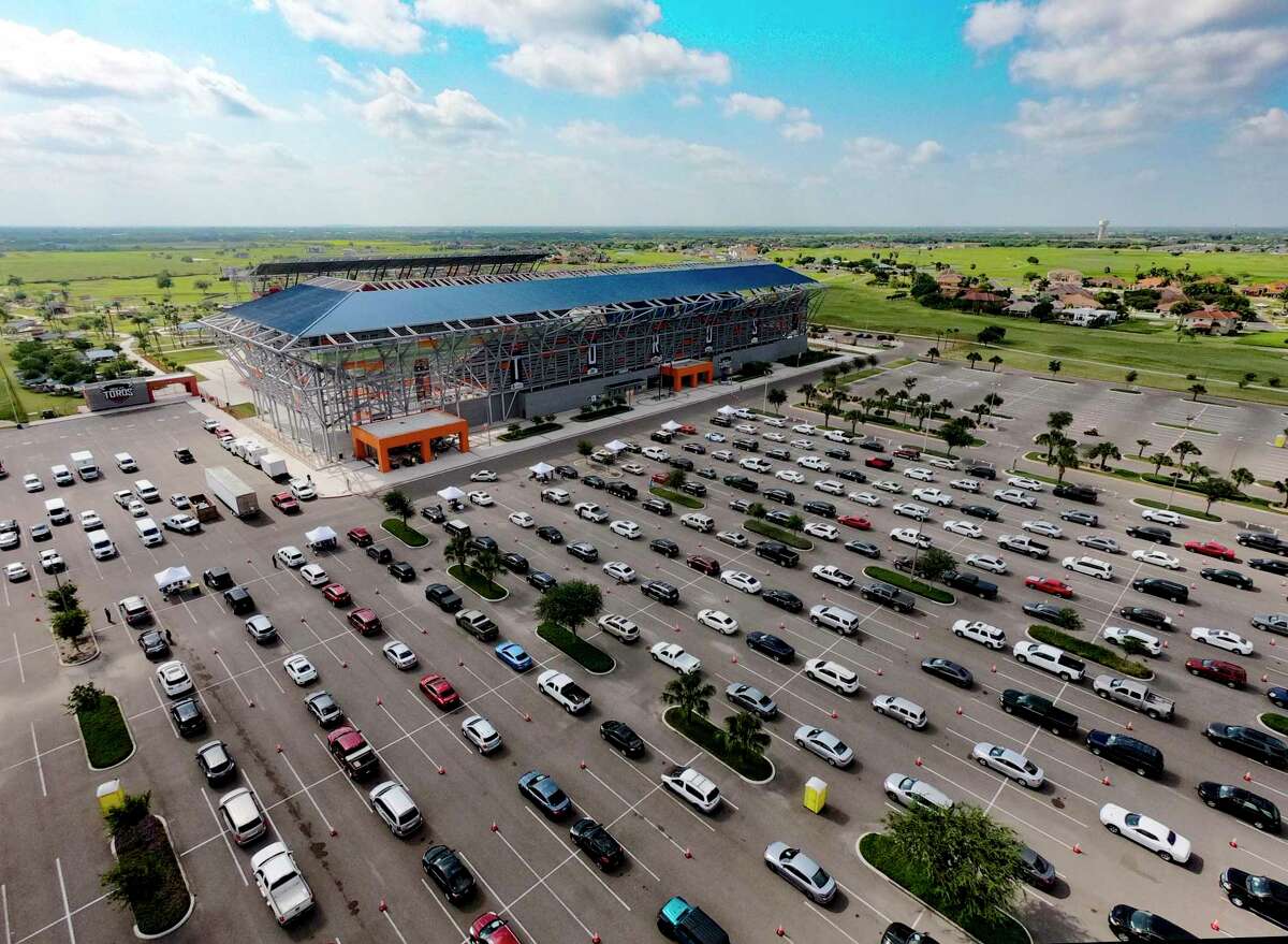 People line up for COVID-19 tests in the parking lot of H-E-B Park soccer stadium in Edinburg on Thursday. The federally run testing site will continue testing patients at Bert Ogden Arena through July 14. Pre-registration is required.