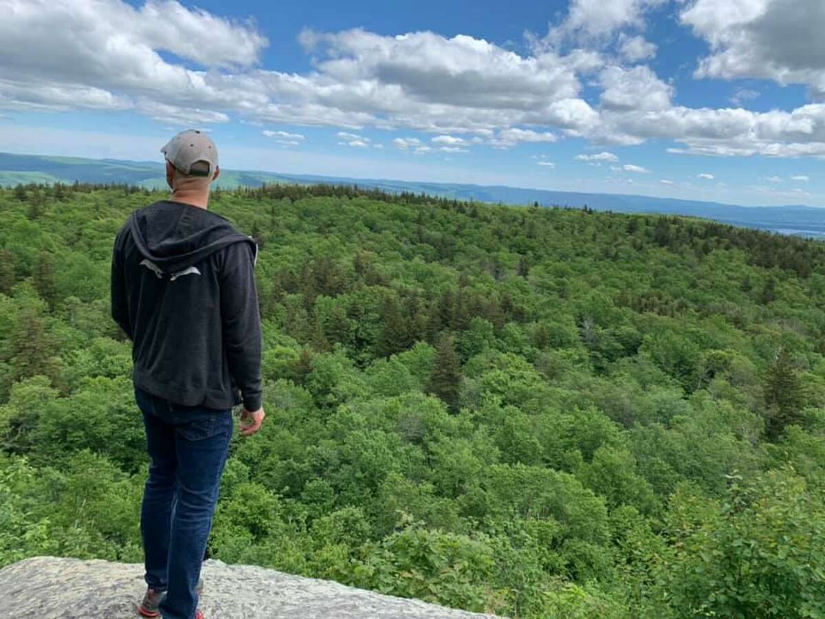 A hiker takes in the view from Mount Greylock in the Berkshires. The summit is at 3,491 feet and offers views of five nearby states due to its isolated location.