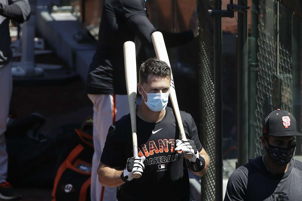 Giants' Buster Posey arrives in camp but says he still might opt out