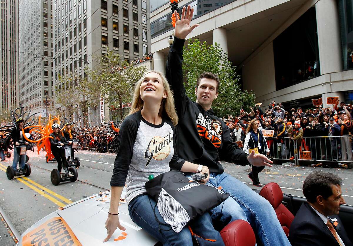 Buster Posey and his wife Kristen waved to the crowds of fans. The San Francisco Giants celebrated their second World Series title in three years with a parade down Market Street Wednesday October 31, 2012.