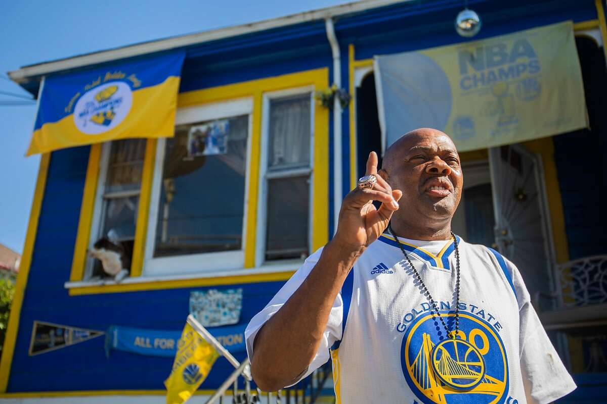 Lloyd Canamore waves at a honking car passing by his warriors home he's lived in his whole life on July 9, 2020 in Oakland, CA.