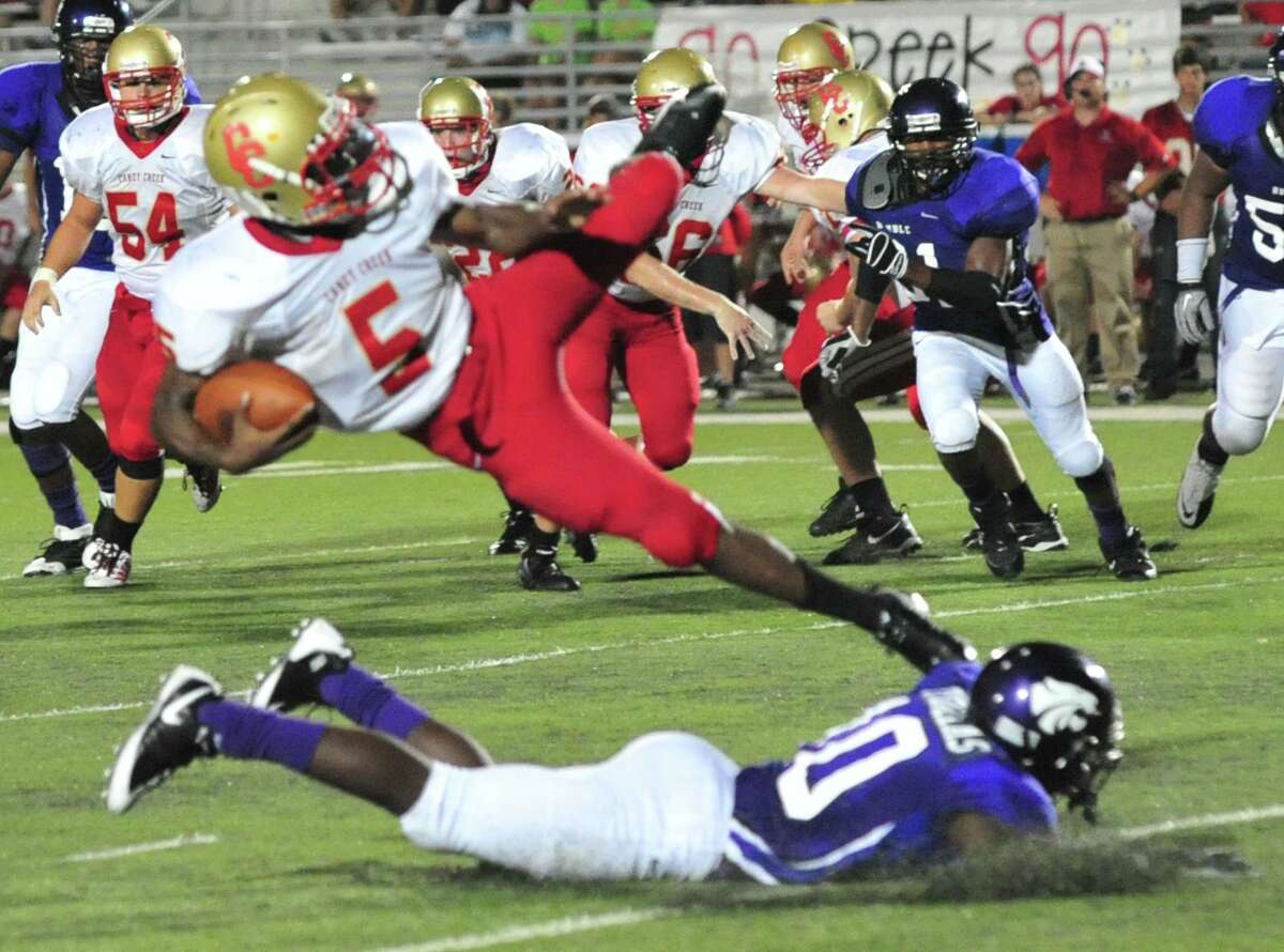 Clifford Thomas tackles Caney Creek's Marquis Sykes in the Wildcats' 37-21 win on Sept. 24.