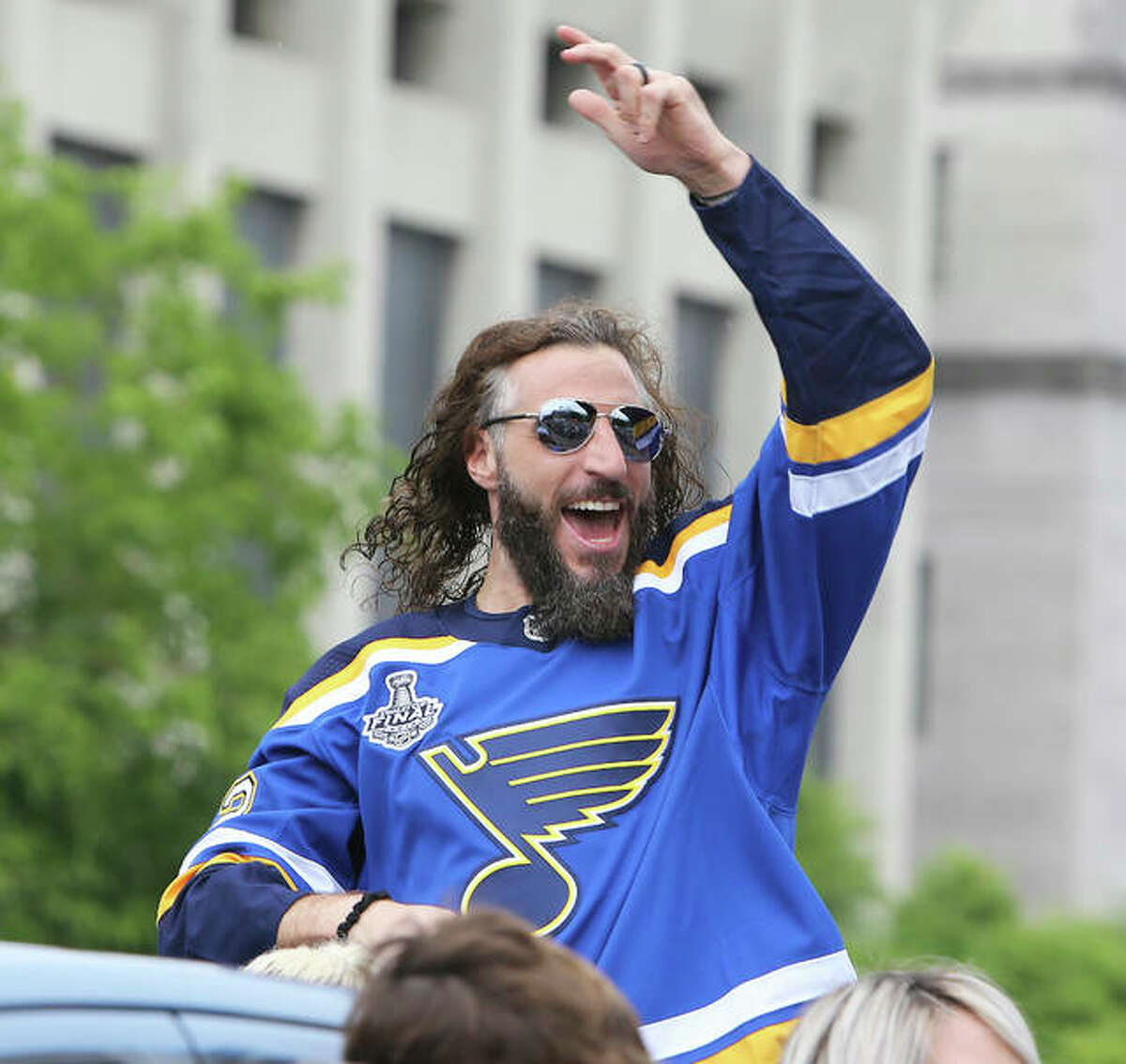 St. Louis Blues player Chris Thorburn waves to fans during the NHL Stanley Cup victory parade June 15, 2019 in St. Louis. Thorburn announced his retirement last month, but the Blues will resume the season on Aug. 2.