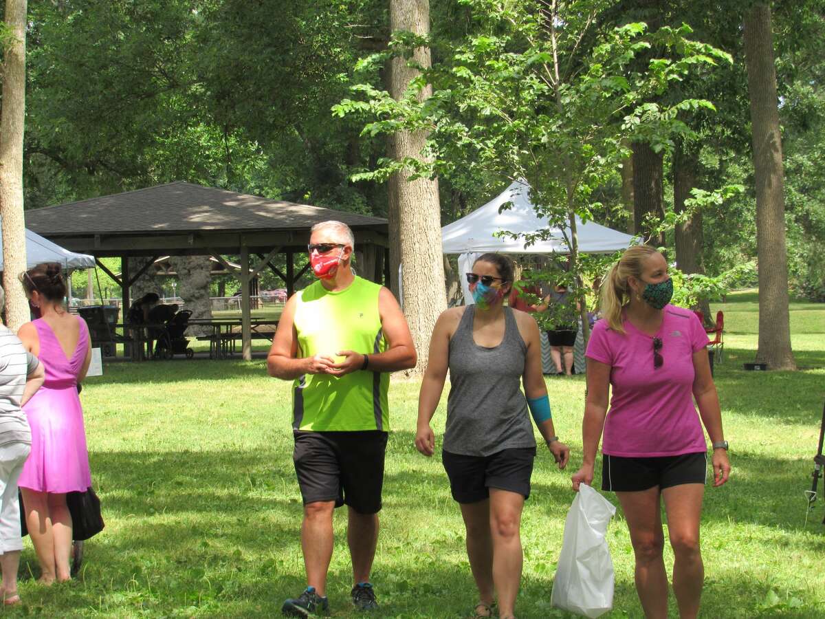 People walk between the tents set up at the Great Lakes Market's Summer Market on Saturday.