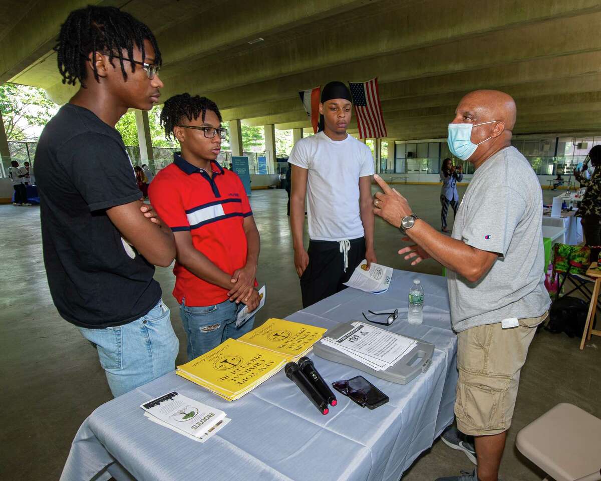 Andre Morris, of Trinity Alliance and Roots, talks about the importance of having a solid resume with Ziair Burden, OJ Jones and Kevin Brown during a Youth Job Fair sponsored by Albany SNUG and the Team Hittaz Boxing Club at the Swinburne Park ice skating rink on Clinton Avenue in Albany, NY, on Saturday, July 11, 2020 (Jim Franco/special to the Times Union.)