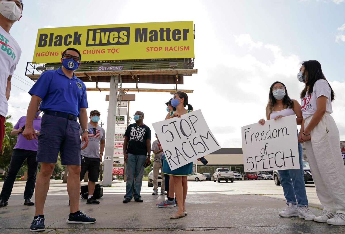 State Rep. Gene Wu, left, joins others Saturday in support of a Black Lives Matter billboard at 11107 Bellaire Blvd.