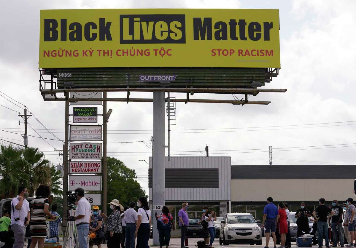 People gather at 11107 Bellaire Blvd. during the protest about the Black Lives Matter billboard Saturday, July 11, 2020, in Houston. A number of people attended who opposed the protest scheduled by the Vietnamese Community of Houston and Vicinity.
