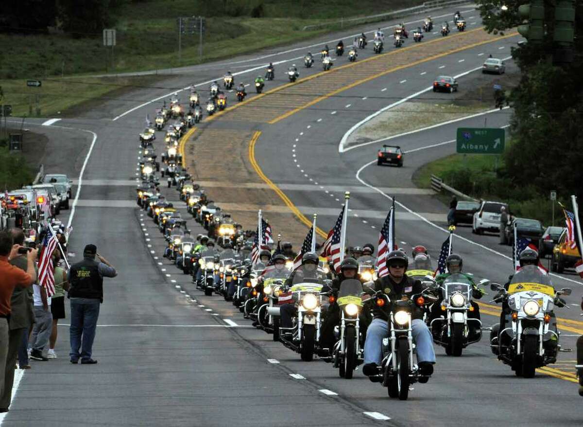 The Patriot Guard Riders motorcycle group precedes the casket carrying the remains of Staff Sgt. Derek Farley down Routes 9 and 20 in Schodack on August 25, 2010. (Skip Dickstein/Times Union)