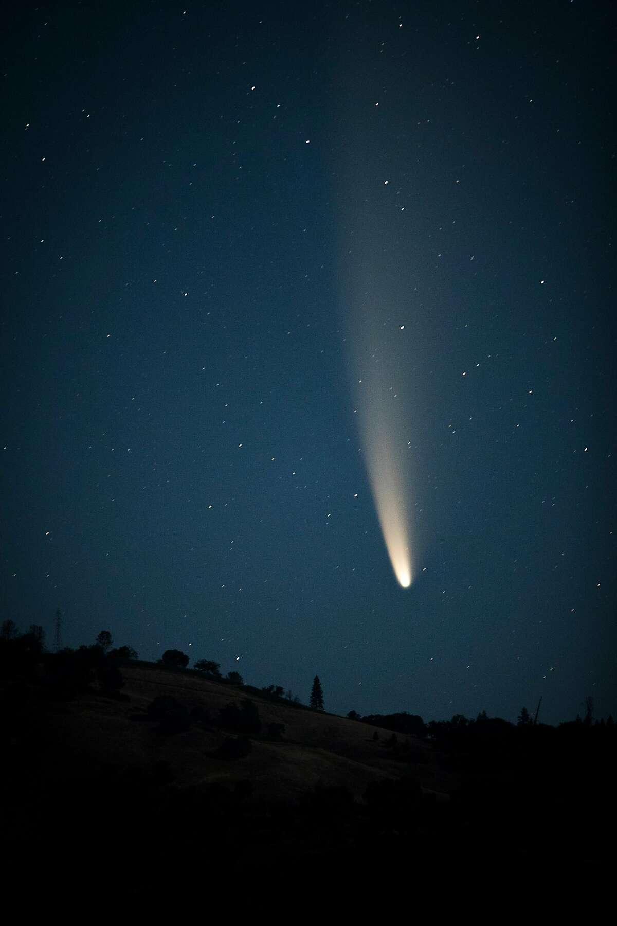 The comet C/2020 F3 (NEOWISE) rises over Clear Lake as seen from Soda Bay Road outside Clear Lake, Calif., on Sunday, July 12, 2020. The comet, only recently discovered, will not return to earth for another approximately 6800 years.