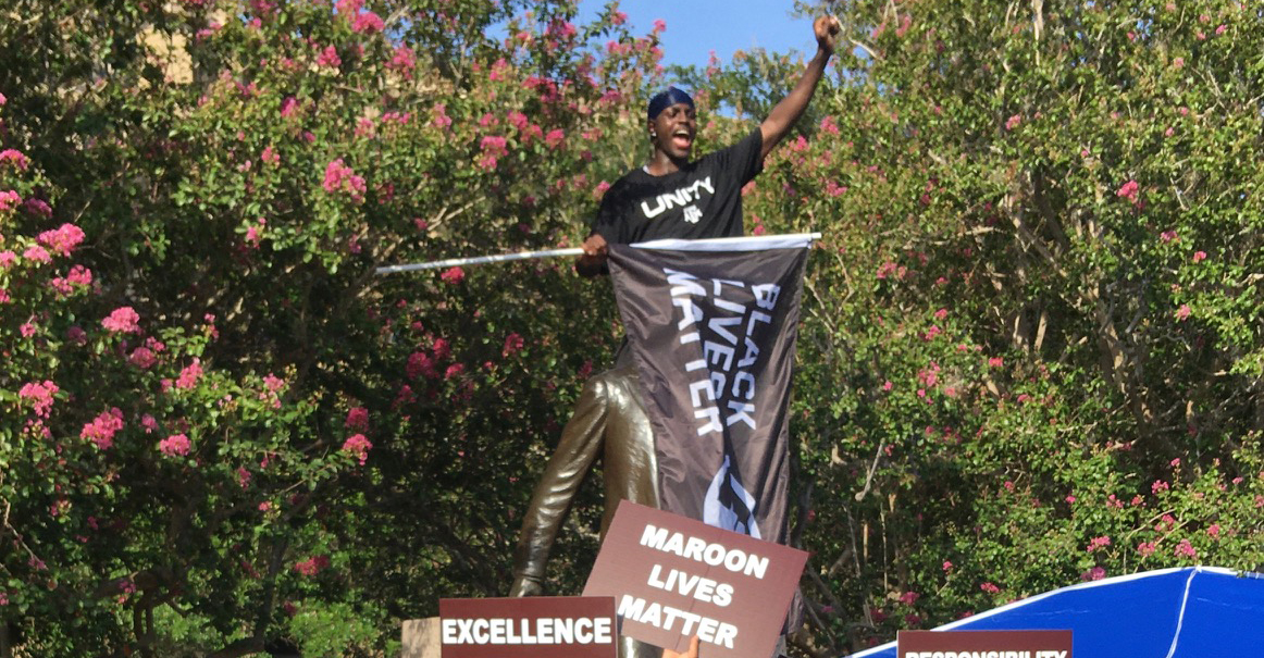 Texas A M athlete climbs on top of Sul Ross statue waves Black Lives
