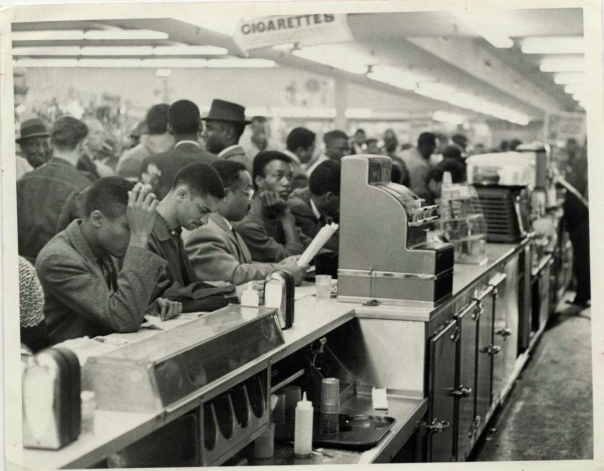 In this file photo from March 1960, student demonstrators, members of the Progressive Youth Association, sit down in protest at a white lunch counter at Weingarten's No. 26, 4110 Almeda. The students, mostly from TSU, occupied all 30 stools at Weingarten's lunch counter. Jim Morgan/© Houston Chronicle