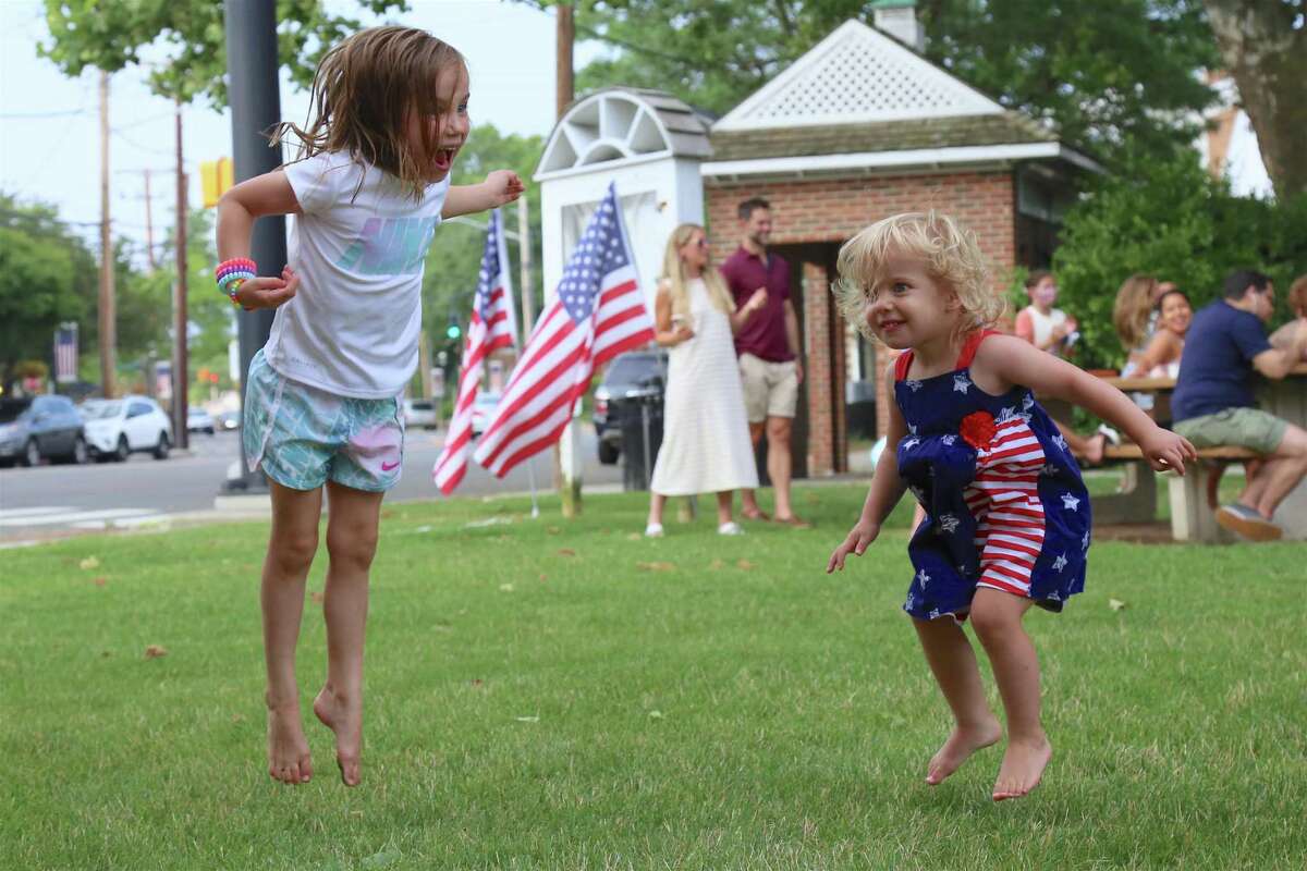Lily Macchia, 5, left, of Fairfield, and her sister Alyssa, 2, do some dancing at this season's first Sherman Green Summer Concert on Saturday, July 11, 2020, in Fairfield, Conn.