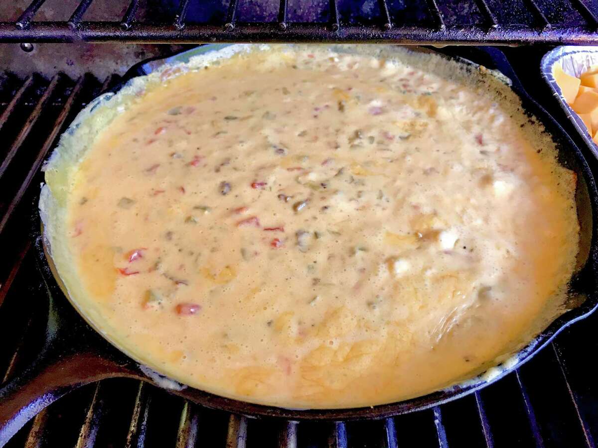 Smoked queso can be made in a cast iron pan on an outdoor gas grill. With or without smoking, the queso is delicious.