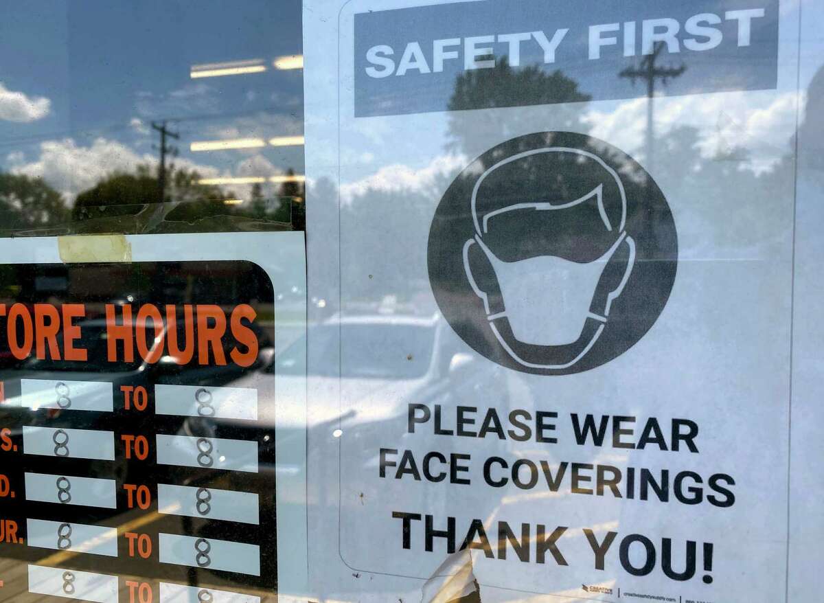 Signs urging customers to wear masks are posted on the front door of a True Value Hardware store on Monday, July 13, 2020, in Bethlehem, N.Y. (Will Waldron/Times Union)