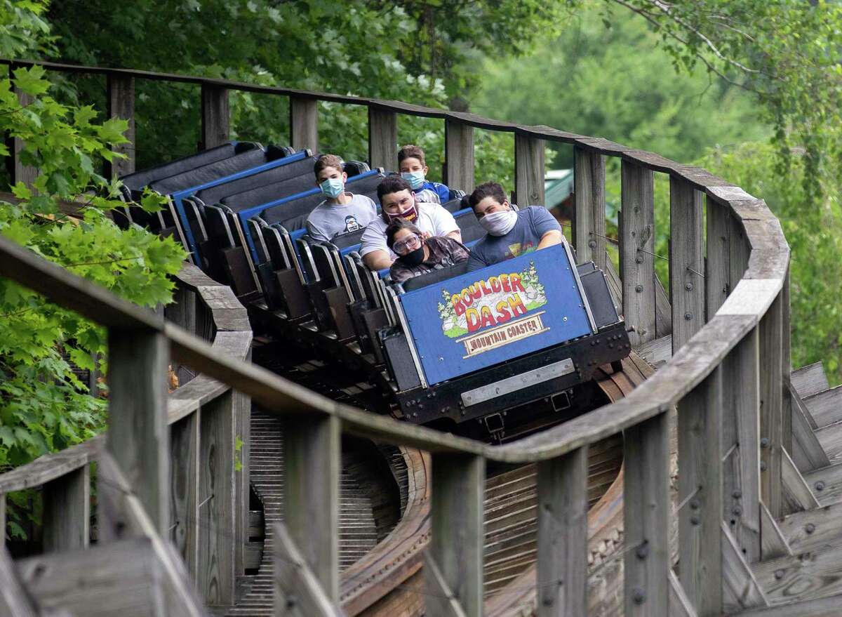 Riders wear their mask as they ride Boulder Dash at Lake Compounce July 7 in Bristol. Wearing masks in public and social distancing are necessary to keep the coronavirus from spreading widely.