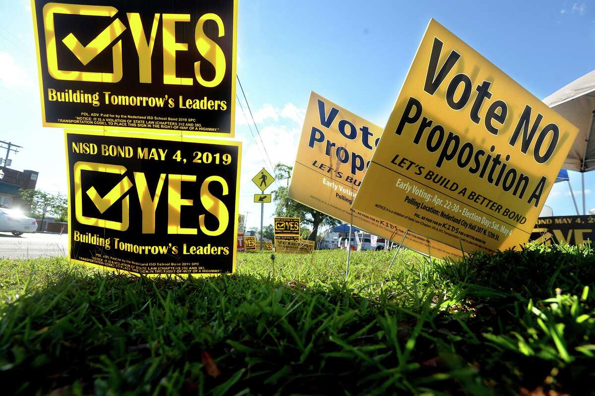 Election signs fill the grassy area across from City Hall in Nederland, which is the polling site for early voters. The majority are urging yes and no votes to the NISD bond proposal. Photo taken Thursday, April 25, 2019 Kim Brent/The Enterprise