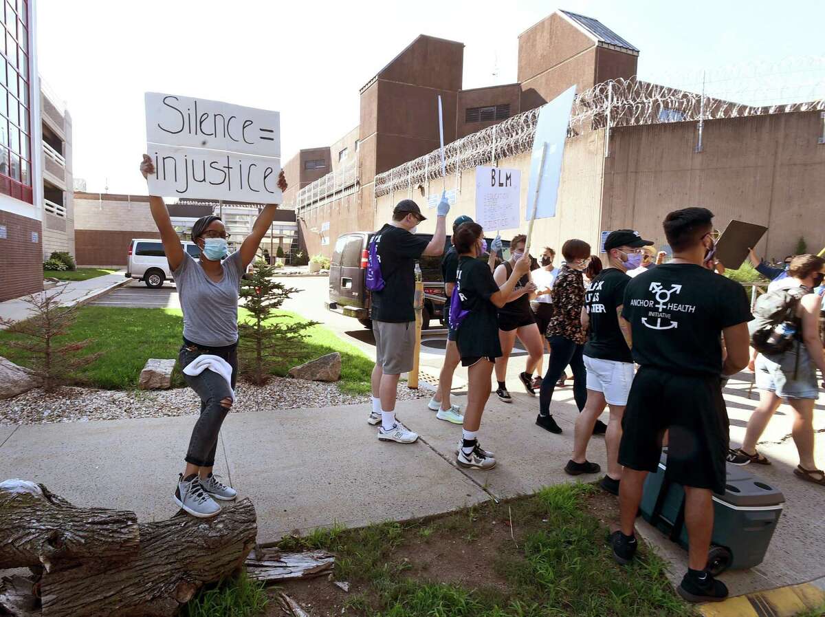 Approximately 50 people rally and march around the New Haven Correctional Center Monday to bring awareness to alleged police violence and abuse.