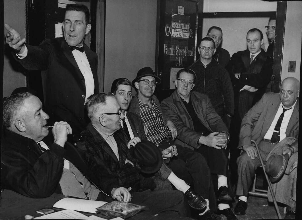 New York - J. Willard Frament gestures as he says: "We are the Republican Party in Cohoes." Surrounding him are the committeemen who moments before gave him a vote of confidence. Standing in the rear are two "representatives" of the Albany County GOP committee which has announced a reorganization of the Cohoes GOP party. Seated left to right are committeemen Homer Senecal, Paul Krug, Alfred J. Brackley, Eugene Benoit, Wilfred Seguin and , far right, Marcel A. Roberts. Standing in the door, left to right, are Gabriel T. Couture, Michael Steele, Ralph Surzy, representing the Albany County GOP committee, and Jacob Millett. March 05, 1964 (Bob Richey/Times Union Archive)