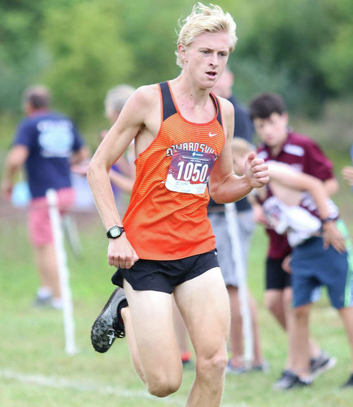 Edwardsville senior Jack Pifer pushes the the finish line in first place at the Edwardsville Invitational on Sept. 21 at SIUE. Pifer will continue his running career at Saint Louis U.