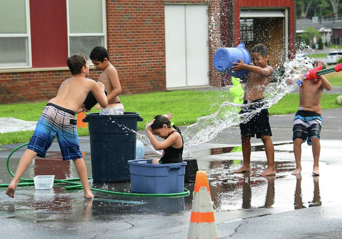 From left, Branden Redick, 11, Arkaiss Rosario-Blanco, 10, Kylie McGough, 10, Roman Harris, 8, and Carter Sale, 9, enjoy water play time at TSL (Together, Sharing, Learning) Kids Crew summer camp at the former Christ Lutheran Church on Western Ave. Tuesday, July 14, 2020 in Guilderland, N.Y. (Lori Van Buren/Times Union)