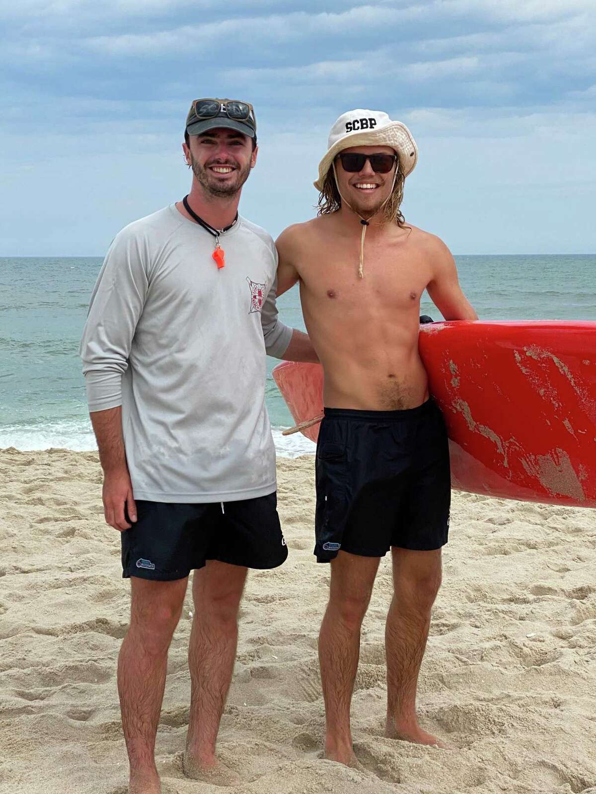 Lifeguards Charlie Osborne of New Milford, left, and Scott Meggitt recently rescued a pilot from the water after his banner plane crashed into the waters off the shores of Surf City, N.J.