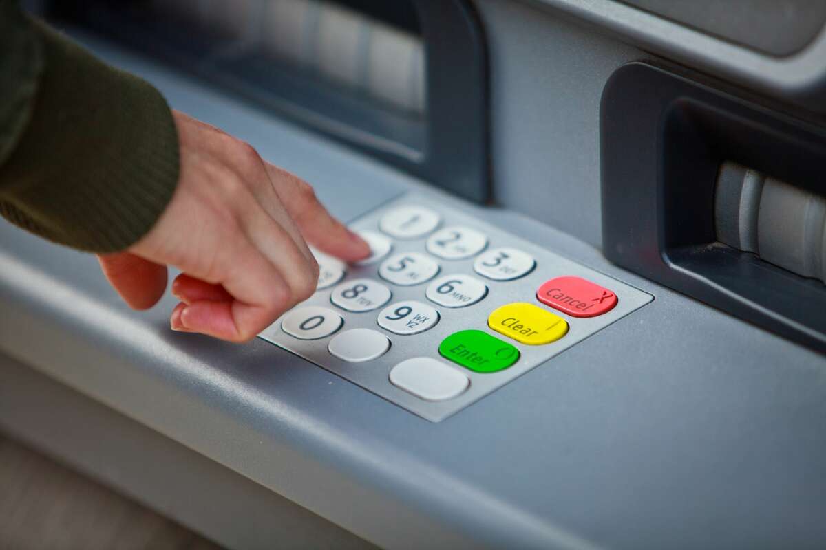 A man uses an ATM in this file photo.