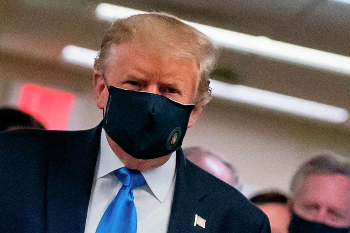 President Donald Trump wears a mask for the first time publicly as he visits Walter Reed National Military Medical Center in Bethesda, Maryland on Saturday.