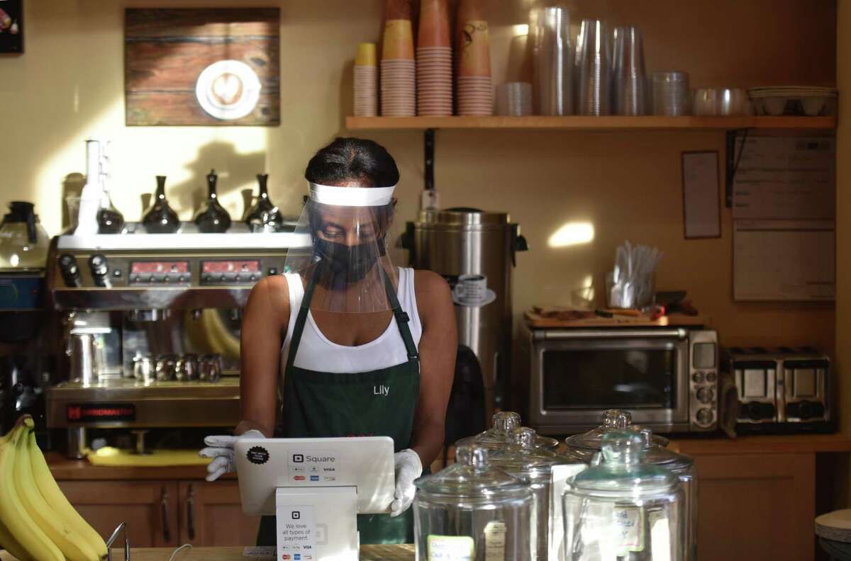 Lily Damtew, owner of Abyssinia Market and Coffee House reopens her small business in Alexandria, Va., on Saturday, July 11, 2020.