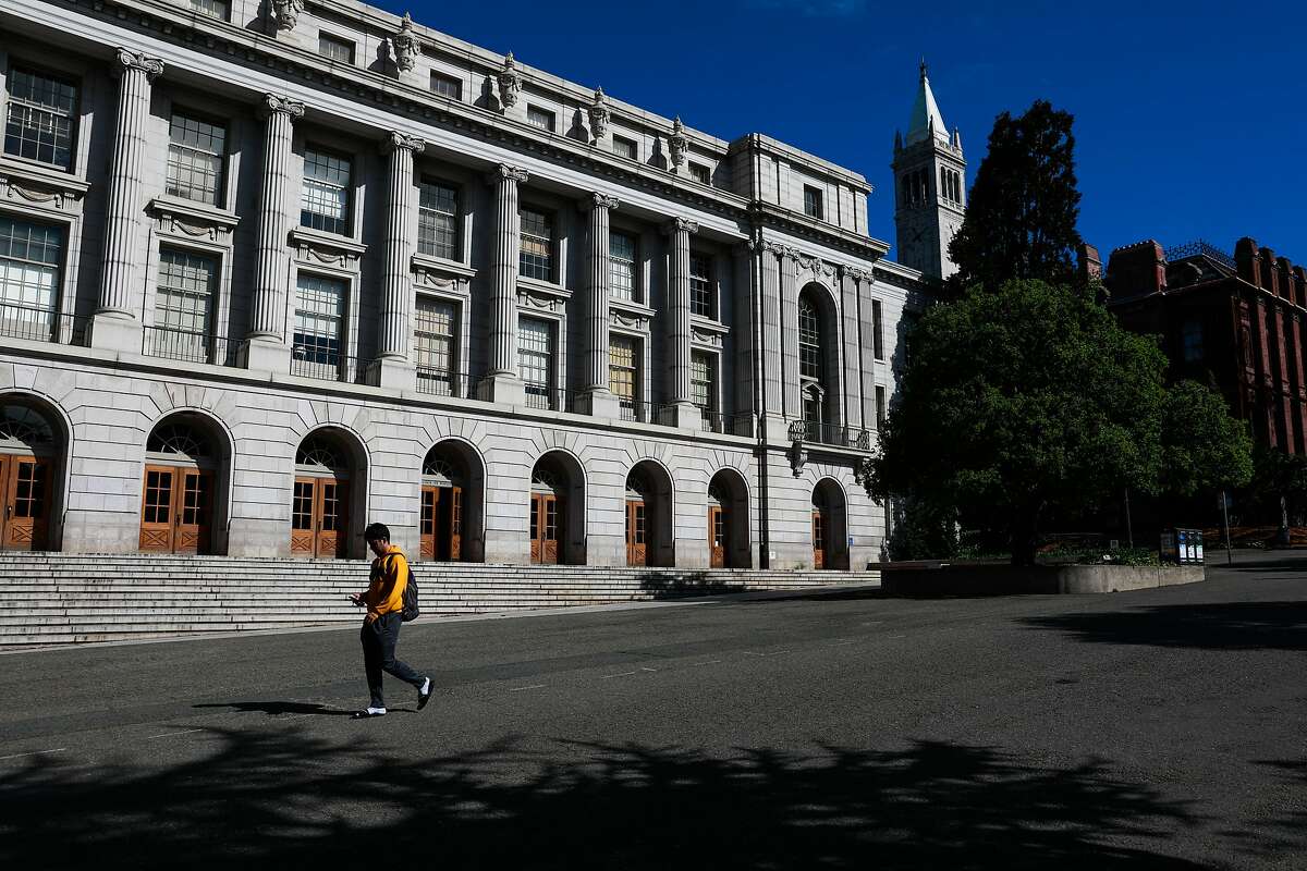 A person walks through the UC Berkeley campus passing Wheeler Hall a day after Berkeley suspended in-person classes through the end of Spring break due to the coronavirus on Tuesday, March 10, 2020 in Berkeley, California.