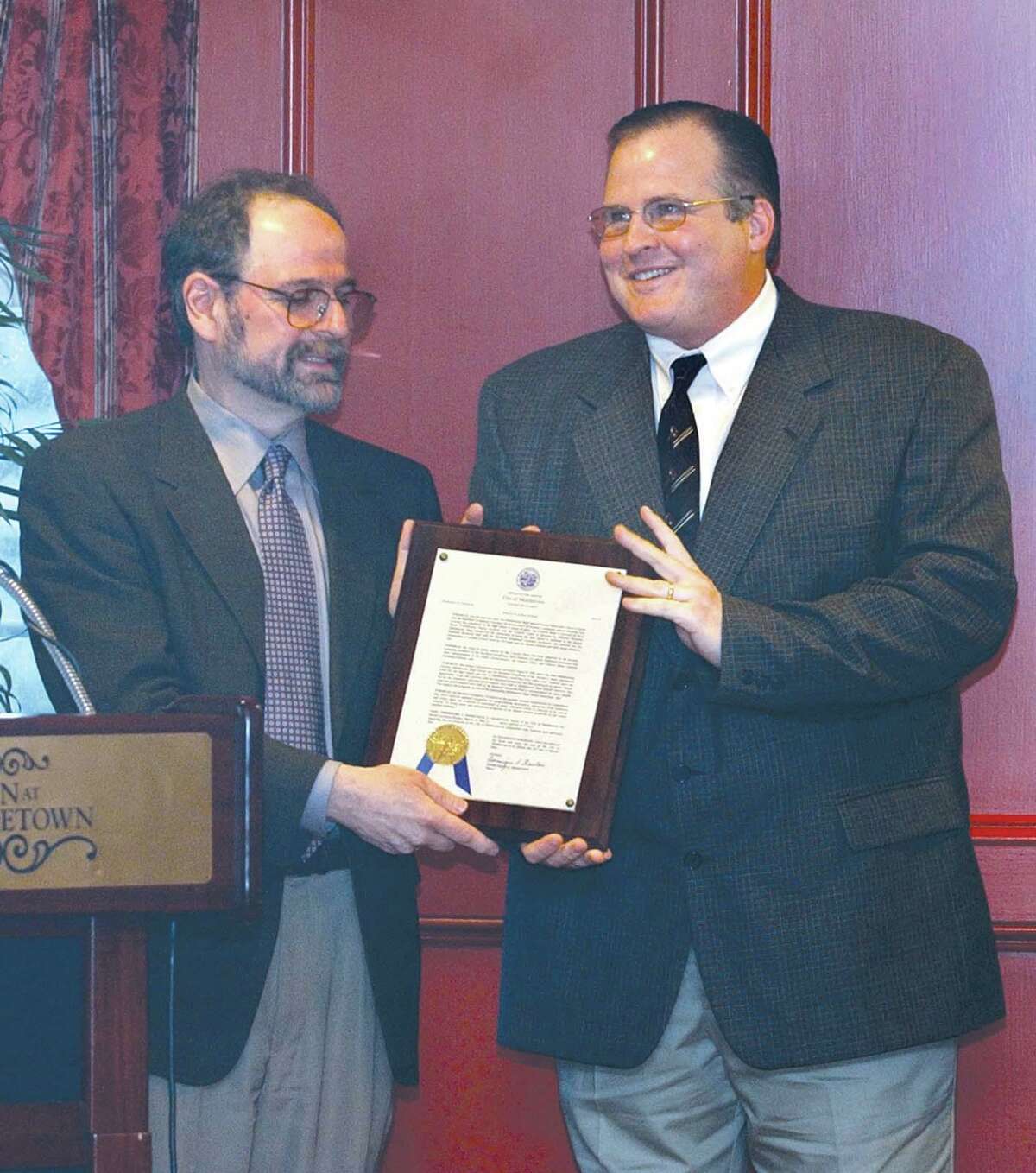In this 2004 photo, former Middletown Commission on the Arts chairman Richard Kamins, left, presents one of two Arts Advocacy Day awards to Marco Gaylord, director of the Middletown High School Band, at a ceremony at The Inn at Middletown.