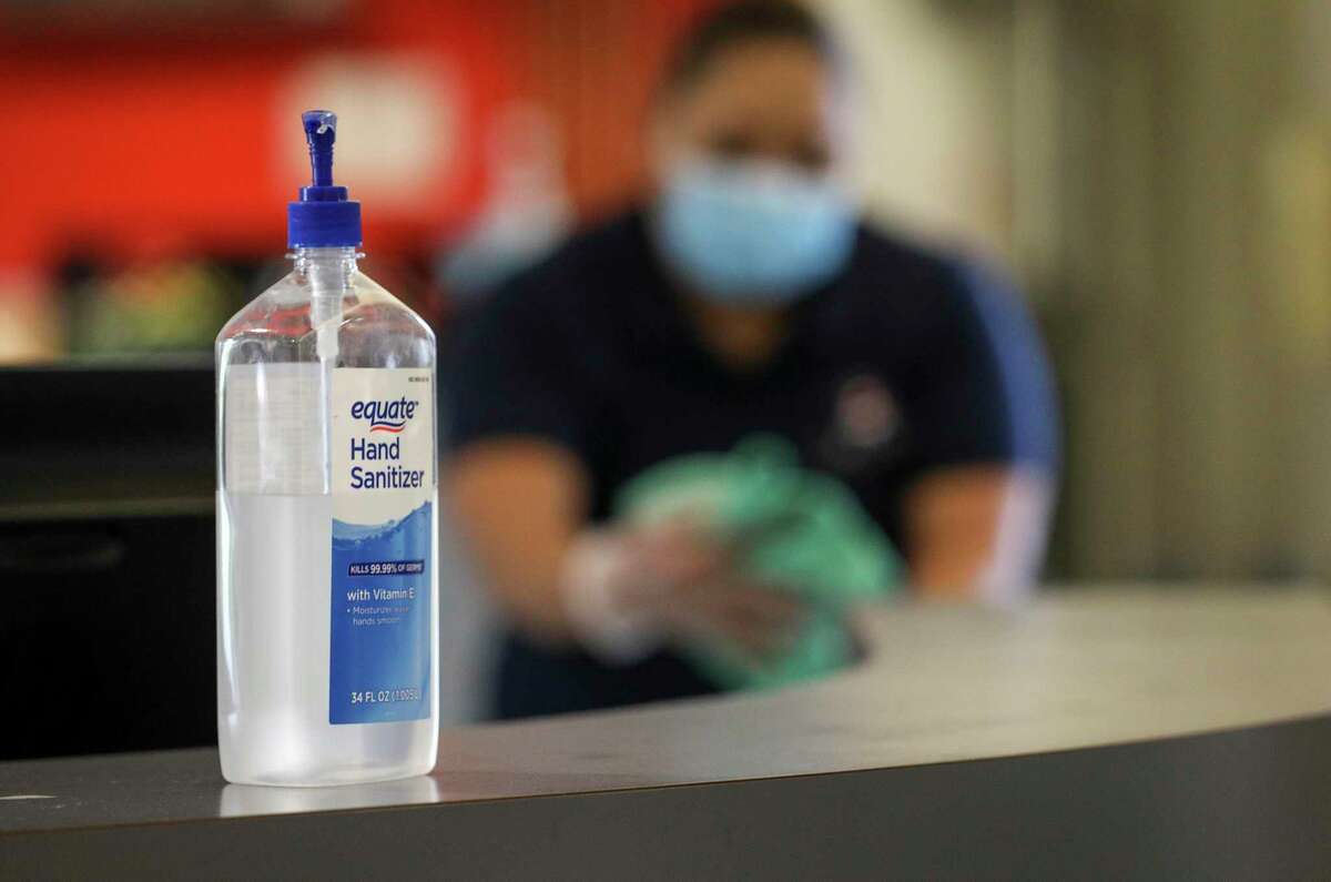 A bottle of hand sanitizer is seen as Rita Funez cleans Tuesday, July 14, 2020, at the Quillian Center in Houston.