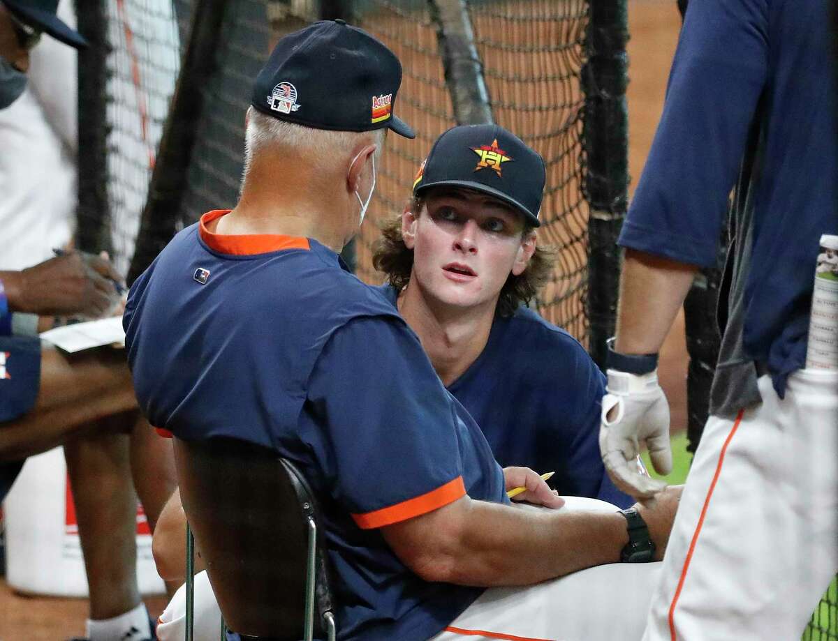 Forrest Whitley, right, has the ear and eyes of Astros pitching coach Brent Strom, who says the franchise’s top prospect has “electric stuff.”