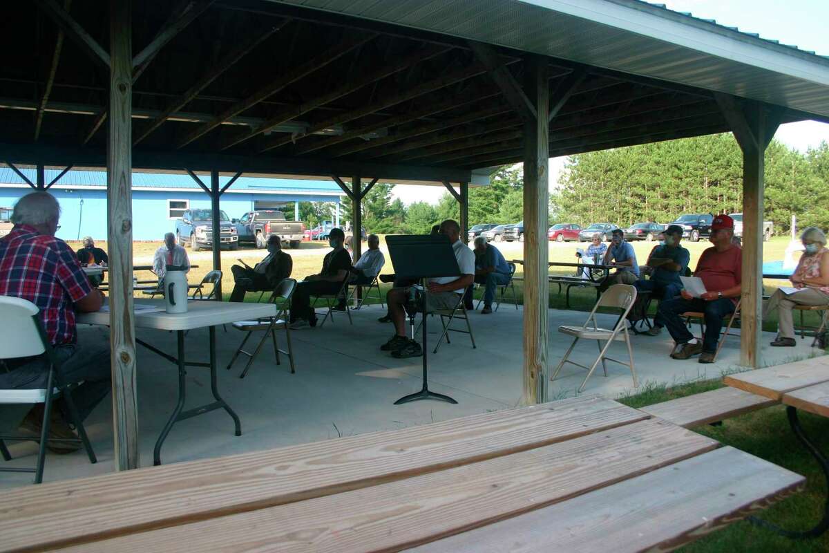 The Evart Township Board of Trustees met outside at the VFW pavilion July 7. It was the first in person meeting since the coronavirus pandemic began. The meeting was held outside to accommodate more public attendance and adhere to social distancing. (Herald Review photo/Cathie Crew)