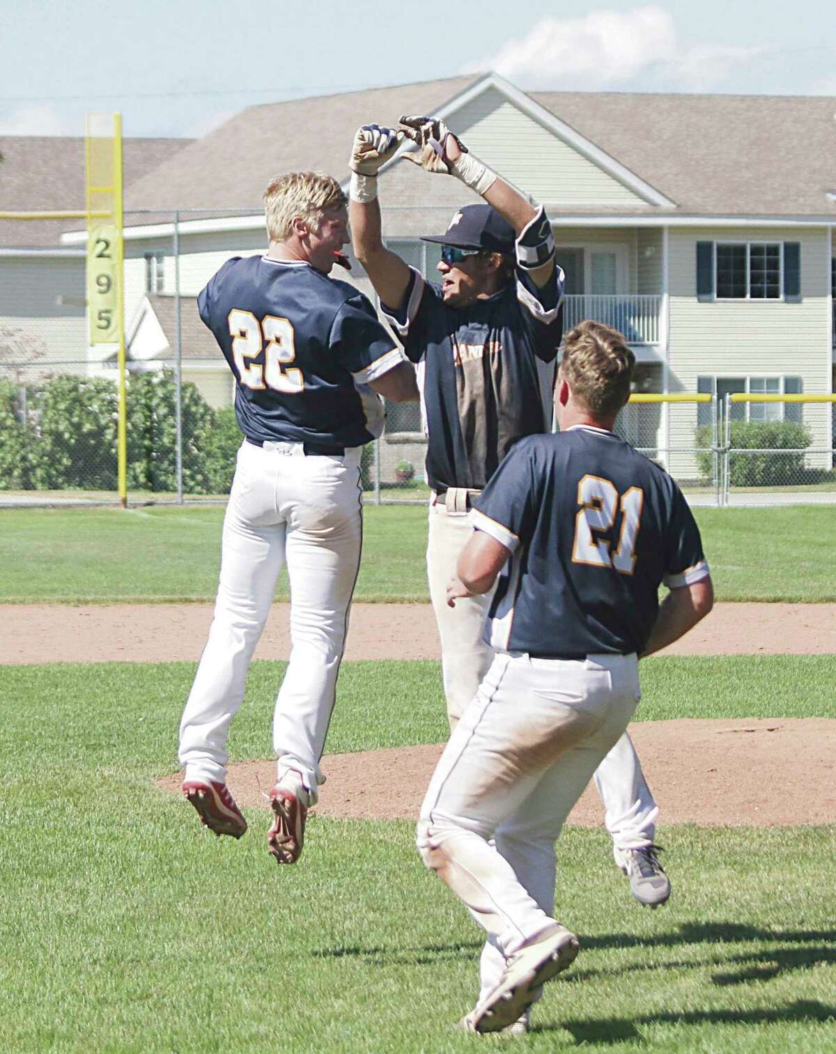 The Manistee Saints celebrate their walk-off win Sunday that salvaged a series split with the Oil City Stags. (Dylan Savela/News Advocate)