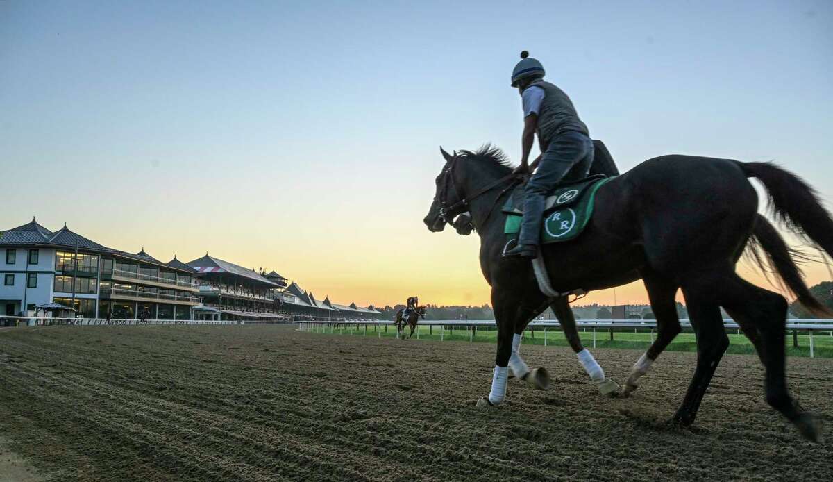 An exercise rider watches as horses gallop in the early morning the day before opening day at Saratoga Race Course July 15, 2020 in Saratoga Springs, N.Y. Photo by Skip Dickstein/Special to the Times Union.
