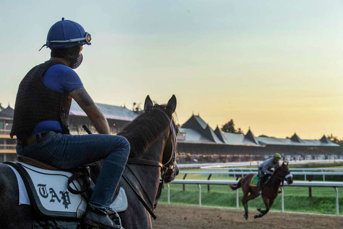 An exercise rider watches as horses gallop in the early morning the day before opening day at Saratoga Race Course July 15, 2020 in Saratoga Springs, N.Y. Photo by Skip Dickstein/Special to the Times Union.