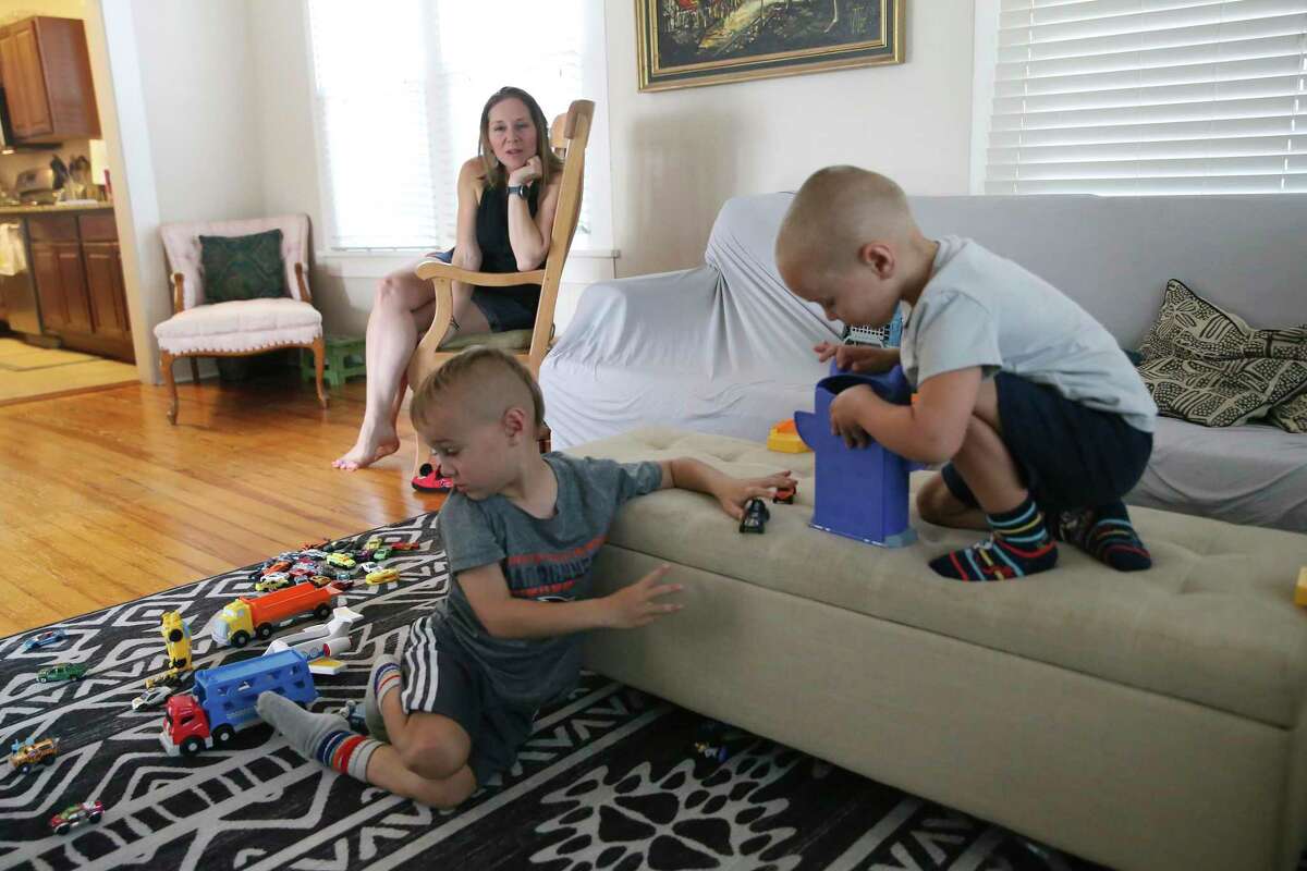 Christy Rosenfeld watches her sons, Anders, 6, left, and Corbin, 4, play in their living room. Child development experts say it is possible to prepare children to return to school safely by following coronavirus health protocols that will limit their risk.