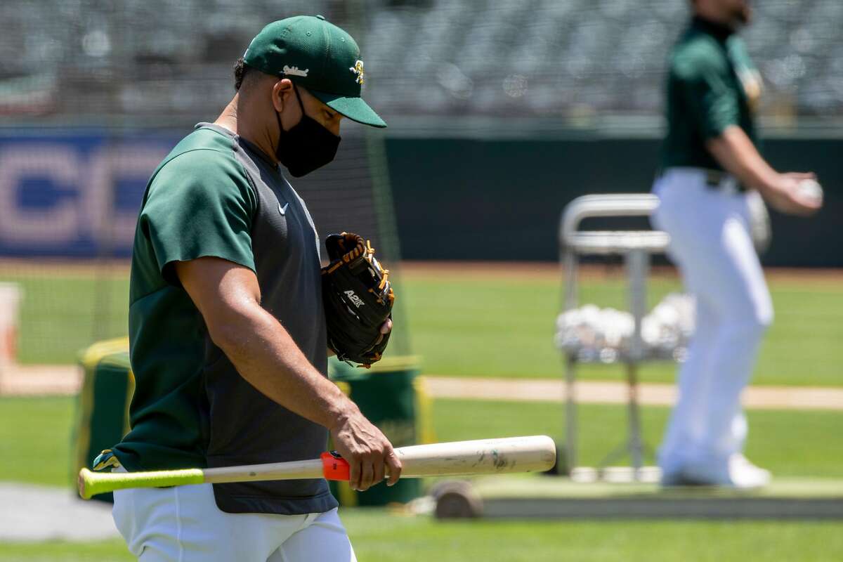 Oakland A's shortstop Franklin Barreto wears a mask while participating in an Oakland A's training camp workout at O.Co Coliseum in Oakland, Calif. Tuesday, July 7, 2020. Due to COVID-19, the 2020 MLB season has been postponed with players just beginning to return for warmups and practices while wearing masks and keeping social distance.