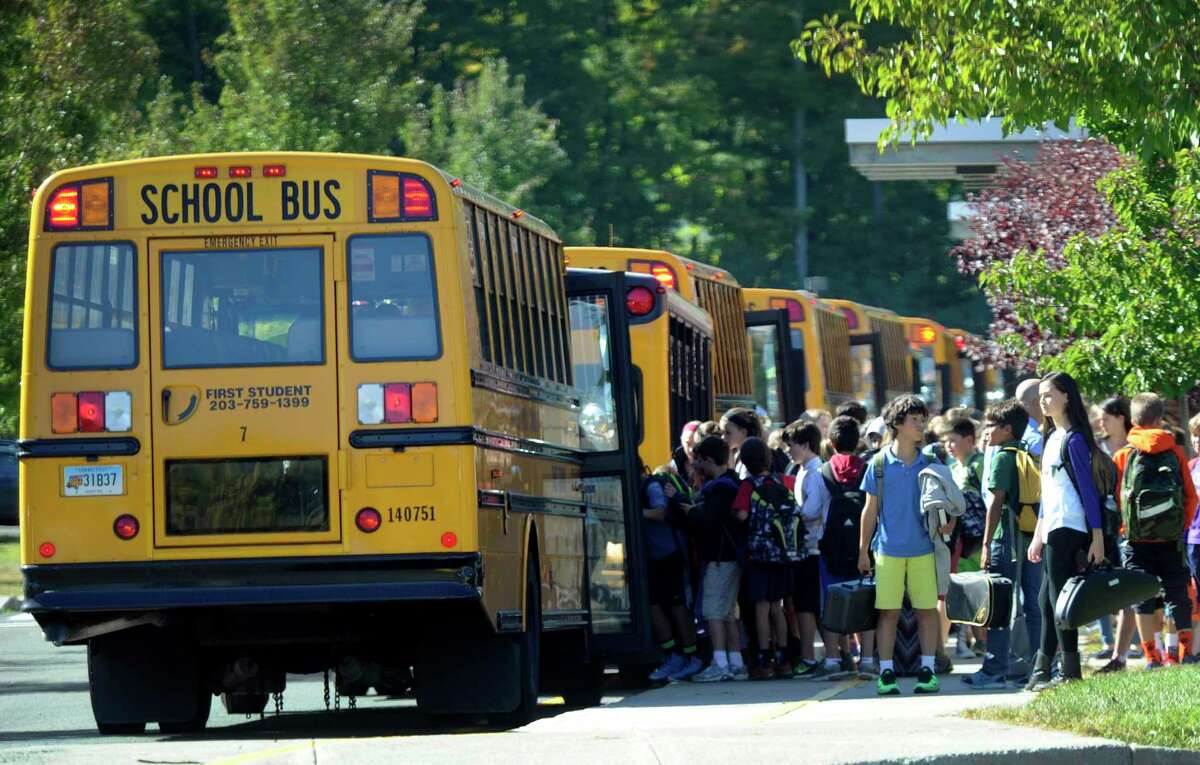 Students board buses at the end of the school day at Scotts Ridge Middle School in Ridgefield, Conn., Tuesday, Sept. 23, 2014.
