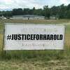 A large sign in Route 9 outside Kinderhook that's part of a campaign calling for the Columbia County Sheriff's Office to finish the investigation of who assaulted Harold Handy at a July 4th party at a residence in Kinderhook, N.Y. Residents are questioning why the investigation is taking so long.