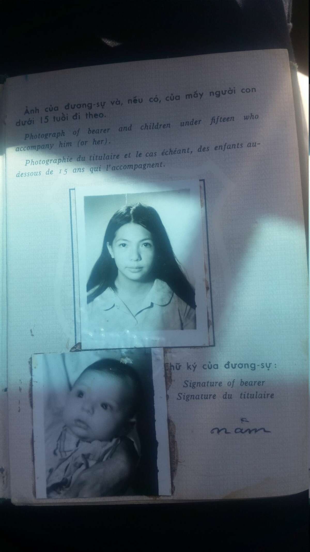 Visa photographs of Kim Remzi as a baby and her mother.