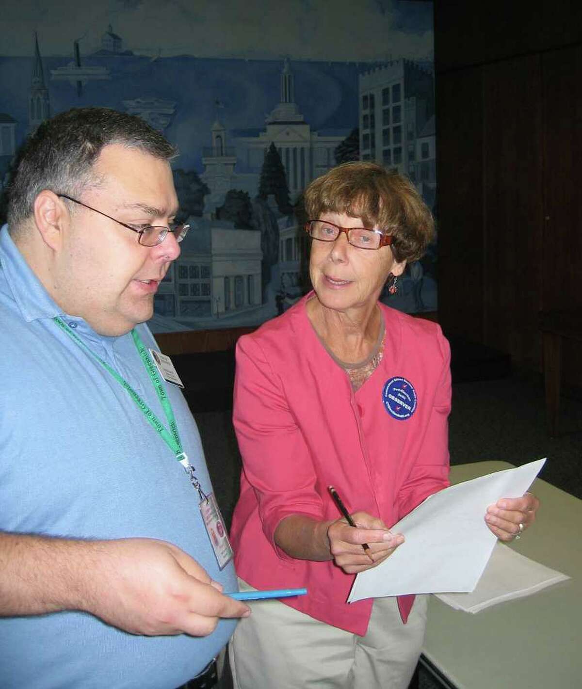 Republican Registrar of Voters Fred DeCaro III answers questions from Ellen McBride, a volunteer post-election observer from the Connecticut Citizen Election Audit Coalition, Wednesday at Town Hall. The state-mandated audit showed no major irregularities in the Aug. 10 primary results from Riverside School.