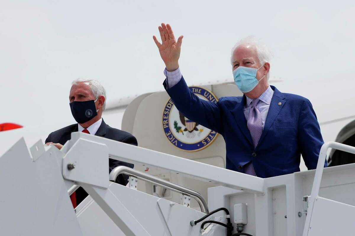 Vice President Mike Pence looks on as Sen. John Cornyn, R-Texas, waves as they board the aircraft to depart for Washington D.C. from Love Field in Dallas, Sunday, June 28, 2020. (AP Photo/Tony Gutierrez)