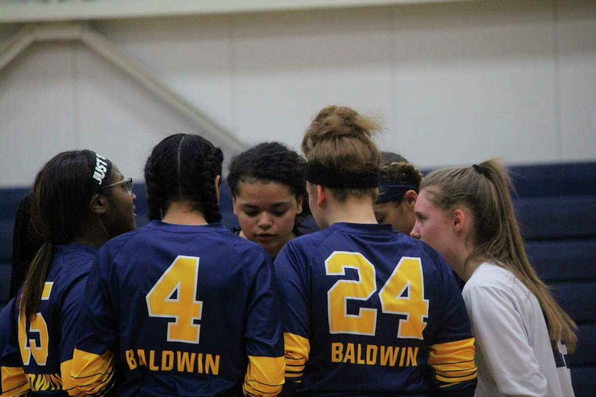 Baldwin volleyball players work on pregame strategy prior to a match last season. (Star file photo)
