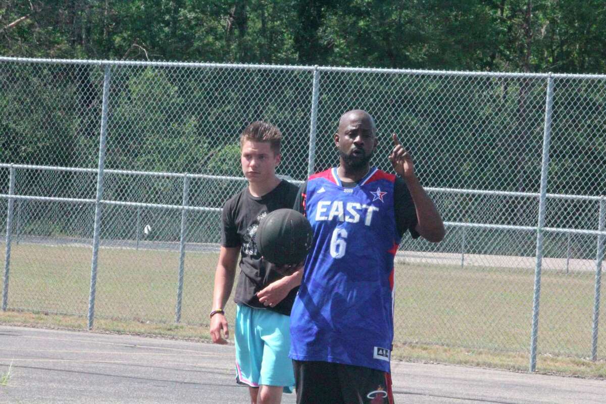 Elliot Lindsey (right) makes a point to Jamison Hunter and other players during Saturday's Future Stars Become Legendary practice at Hollister Park. (Star photo/John Raffel)