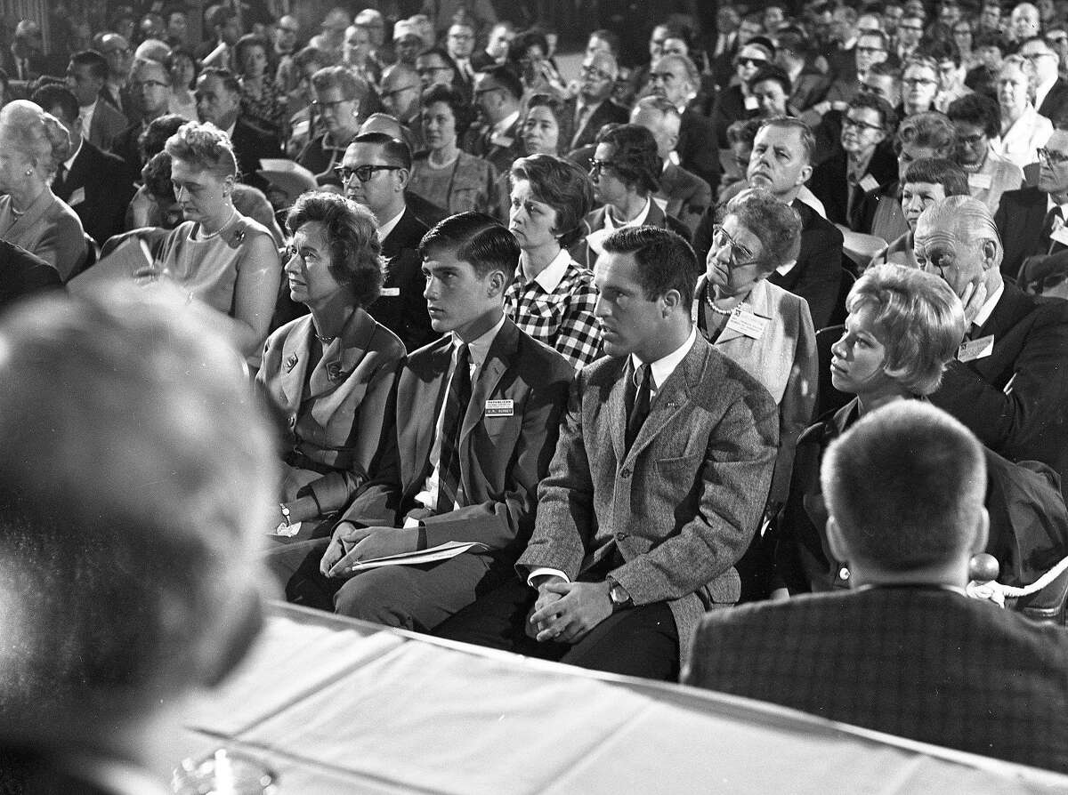 Mitt Romney with his mother and brother Scott, listening to his father speak at the St. Francis Hotel, in advance of the 1964 GOP Convention.