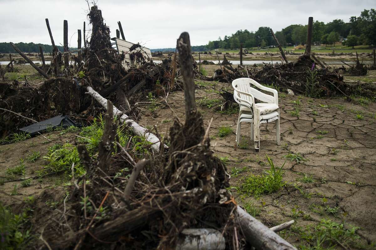 Debris is strewn about the lakebed of Sanford Lake Thursday, July 16, 2020 near N. Water Road. (Katy Kildee/kkildee@mdn.net)