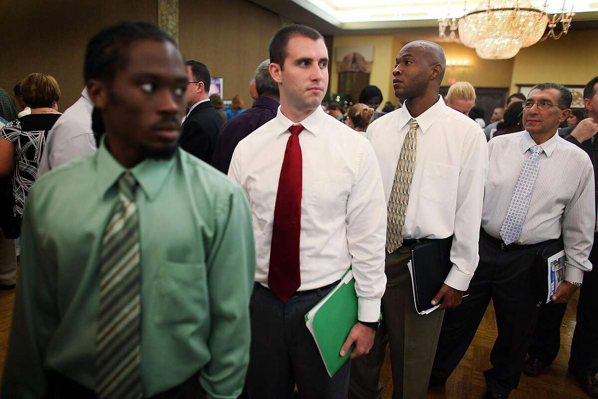 DAVIE, FL - SEPTEMBER 24: Rashad Ingraham (L-R) William Haselberger, Dietrick Purvis and Carlos Estevez, all unemployed, look for a job at the Diversity Job Fair on September 24, 2009 in Davie, Florida. Employers were hiring for positions in all types of industries such as law enforcement, waste management, insurance. (Photo by Joe Raedle/Getty Images)