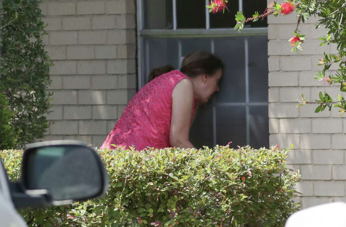 Charlyn Bhatti prays and leads Bible study with her 89-year-old mother, Roselyn Brown through a closed window on the side of Windsong Care Center Thursday, July 16, 2020, in Pearland.
