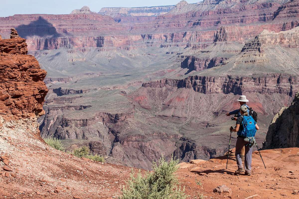 FILE -- Hikers walk by the edge of the cliffs of the Grand Canyon on May 15, 2019. (Sebastien Duval/AFP/Getty Images/TNS)